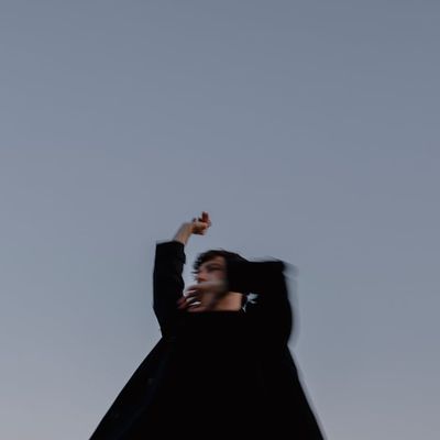 Blurred silhouette of a person in a dynamic pose.