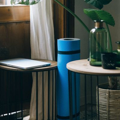 Yoga mat rolled out in a quiet, empty room.